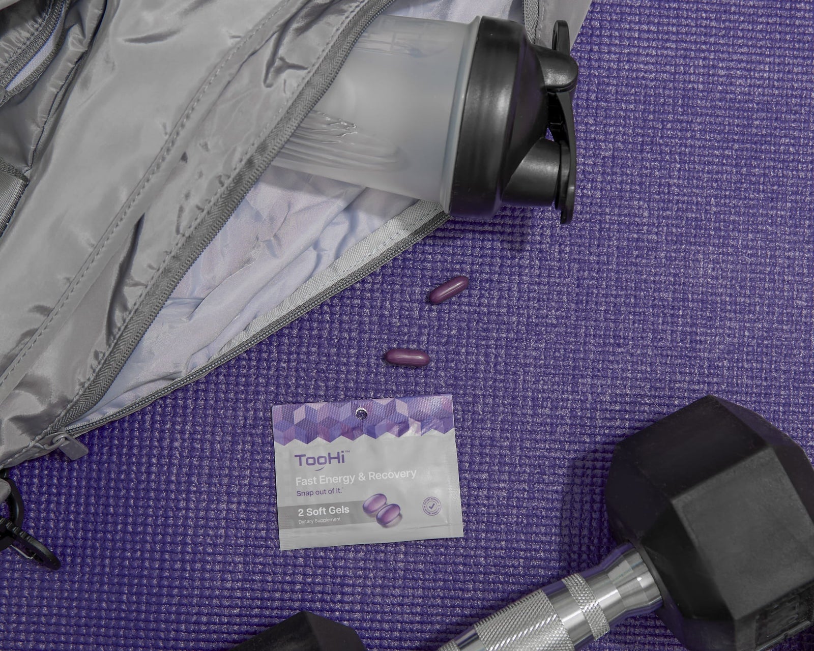Gym essentials with energy supplements and dumbbell